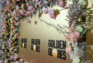 16 February 2024, Berlin: A photo wall with the Golden Globes logo and real flowers stands at a Golden Globes reception at the China Club. Photo: Jens Kalaene/dpa (Photo by Jens Kalaene/picture alliance via Getty Images)