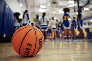 MANASSAS, VA - JANUARY 17: A general view of a ball on the court as head coach Chrissy Kelly of the Osbourn Park Yellowjackets speaks with players during the girl's varsity basketball practice at Osbourn Park High School in Manassas, Virginia on January 17, 2024. (Photo by Scott Taetsch for The Washington Post via Getty Images)