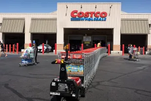 HAWTHORNE, CALIFORNIA - APRIL 04: An employee delivers a row of shopping carts  to the front of a Costco warehouse on April 4, 2025, in Hawthorne, California. Costco Wholesale Corporation, one of the largest retailers in the world with nearly 900 stores worldwide, achieved about $250 billion in sales in 2024 and has been negotiating with suppliers to cut prices, to help offset President Trump's tariffs. (Photo by Jay L Clendenin/Getty Images)