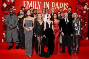PARIS, FRANCE - DECEMBER 15: (L-R) Samuel Arnold, Thalia Besson, Paul Forman, Minnie Driver, Arnaud Binard, Lucien Laviscount, Philippine Leroy-Beaulieu, Lucas Bravo, Eugenio Franceschini, Lily Collins, Bruno Gouery, Ashley Park, guest, William Abadie, Darren Star, guest and Michèle Laroque attend the "Emily In Paris" - Season Five - Netflix Paris Premiere at Le Grand Rex on December 15, 2025 in Paris, France. (Photo by Pascal Le Segretain/Getty Images)