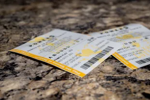 AUSTIN, TEXAS - OCTOBER 10: In a photo illustration, Powerball lottery tickets are seen on a countertop on October 10, 2023 in Austin, Texas. The Powerball jackpot has grown to over $1.7 billion, making it the second-largest jackpot in history. (Photo Illustration by Brandon Bell/Getty Images)