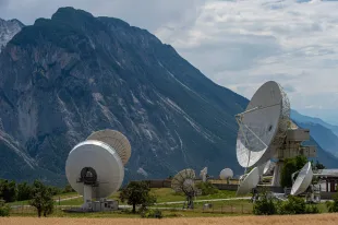 Satellite dishes belonging to local communications provider Leuk Teleport and Data Centre AG stand on a mountainside in Wallis canton (Image via Getty)