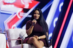 PHOENIX, ARIZONA - DECEMBER 21: Surprise guest Nicki Minaj is interviewed by Erika Kirk on the final day of Turning Point USA's annual AmericaFest conference at the Phoenix Convention Center on December 21, 2025 in Phoenix, Arizona. Minaj spoke about her frustrations with California Governor Gavin Newsom, and about why she has embraced the conservative movement. (Photo by Caylo Seals/Getty Images)
