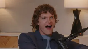 Connor Storrie reacts in disbelief as Andrew Scott’s surprise call comes through during his Shut Up Evan podcast appearance. Image via YouTube/@Evan Ross Katz