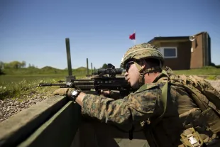 Photograph of US Corporal William Ring using an SA80 A2 assault rifle during the British Royal Marine Operational Shooting Competition held at Altcar Training Camp, Hightown, England, May 14, 2018. (Photo by Smith Collection/Gado/Getty Images)