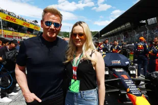 Hell's Kitchen star Gordon Ramsay and Holly Ramsay pose for a photo with the car of Max Verstappen of the Netherlands and Oracle Red Bull Racing on the grid prior to the F1 Grand Prix of Austria at Red Bull Ring on July 02, 2023 in Spielberg, Austria. (Photo by Mark Thompson/Getty Images)