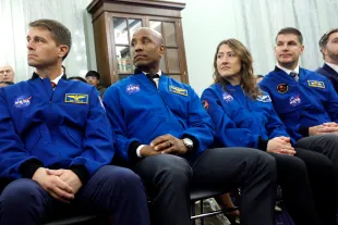 Artemis II astronauts (L-R) Commander Reid Wiseman, Pilot Victor Glover and Mission Specialists Christina Koch and Jeremy Hansen look on as Jared Isaacman, U.S. President Donald Trump's nominee to be National Aeronautics and Space Administration (NASA) Administrator, testifies during a Senate Commerce, Science, and Transportation Committee confirmation hearing in the Russell Senate Office Building on Capitol Hill on April 09, 2025 in Washington, DC. Isaacman, a billionaire entrepreneur and close associate of SpaceX CEO Elon Musk, previously chartered two private astronaut flights to orbit including the all-civilian American "space tourist" Inspiration4 mission (Image via Getty)