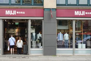 Customers enter the MUJI retail store in Berlin, Germany, on July 21, 2025. The store features minimalist Japanese fashion and household goods across two floors. (Photo by Michael Nguyen)