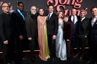 NEW YORK, NEW YORK - DECEMBER 11: (L-R) Jim Belushi, Mustafa Shakir, Craig Brewer, Kate Hudson, Hugh Jackman, Ella Anderson, Hudson Hensley, John Davis, John Fox and Jason Cassidy attend the "Song Sung Blue" New York Premiere at AMC Lincoln Square Theater on December 11, 2025 in New York City. (Photo by Cindy Ord/WireImage)
