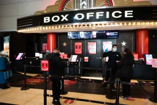 NEW YORK, NEW YORK - MARCH 05: Moviegoers line up at the AMC Lincoln Square 13 box office on March 05, 2021 in New York City. AMC Theatres reopened its New York area locations today, with new safety precautions in place, for the first time since closing in March because of the coronavirus (COVID-19) pandemic. (Photo by Noam Galai/WireImage)