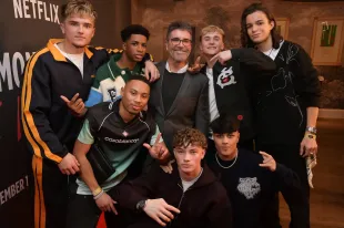 LONDON, ENGLAND - DECEMBER 09: Simon Cowell (C) poses with (L to R) Hendrik Christoffersen, Cruz Lee-Ojo, John Fadare, Josh Olliver, Sean Hayden, Danny Bretherton and Nicolas Alves of December 10 at a friends and family celebration for docuseries "Simon Cowell: The Next Act" hosted by Simon Cowell, Box to Box and Netflix at The Ham Yard Hotel on December 9, 2025 in London, England. The six-episode docuseries will launch December 10 on Netflix. (Photo by Dave Benett/Getty Images for Simon Cowell: The Next Act)