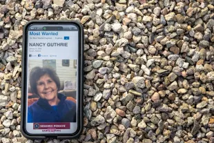 TUCSON, ARIZONA - FEBRUARY 10: In this photo illustration, Nancy Guthrie is seen on the FBI website on a cellular phone February 10, 2026 in Tucson, Arizona. Searches continues for Nancy Guthrie, the 84-year-old mother of U.S. journalist and television host Savannah Guthrie, after she went missing from her home on the morning of February 1st. Guthrie's possible abductors had set a deadline of 5pm on February 9 for a $6 million payment. (Photo by Brandon Bell/Getty Images)