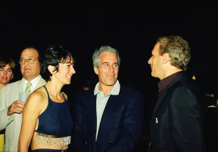 (L-R) Ghislaine Maxwell, Jeffrey Epstein, and musician Michael Bolton pose for a portrait during a party at the Mar-a-Lago club, Palm Beach, Florida, February 12, 2000. (Photo by Davidoff Studios/Getty Images)