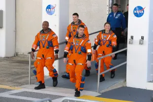 CAPE CANAVERAL, FLORIDA - DECEMBER 20: The Artemis II crew – (L-R) pilot Victor Glover, mission specialist Jeremy Hansen of CSA (Canadian Space Agency), commander Reid Wiseman and mission specialist Christina Koch – rehearse a walkout from the Neil A. Armstrong Operations and Checkout Building at NASA’s Kennedy Space Center in Florida  on December 20, 2025 in Cape Canaveral, Florida. The astronauts are rehearsing for the scheduled February 2026 10-day mission that will carry them around the Moon and back to Earth. (Photo by Joe Raedle/Getty Images)