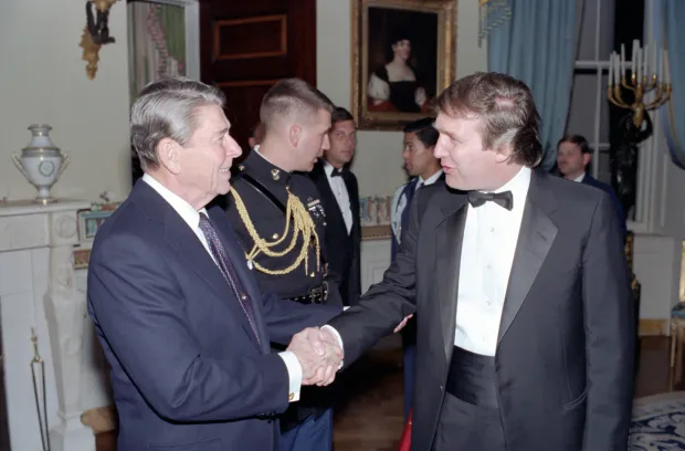 US President Ronald Reagan (1911 - 2004) shakes hands with Donald Trump in a reception line in the White House's Blue Room, Washington DC. November 3, 1987. Now, Trump claims a Canadian politician falsely used a speech by Reagan. (Photo by White House Photo Office/PhotoQuest/Getty Images)