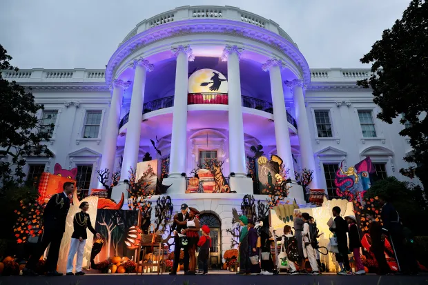 Joe Biden and Jill Biden hand out candy and books during a Halloween trick-or-treat event (Photo by Chip Somodevilla/Getty Images)
