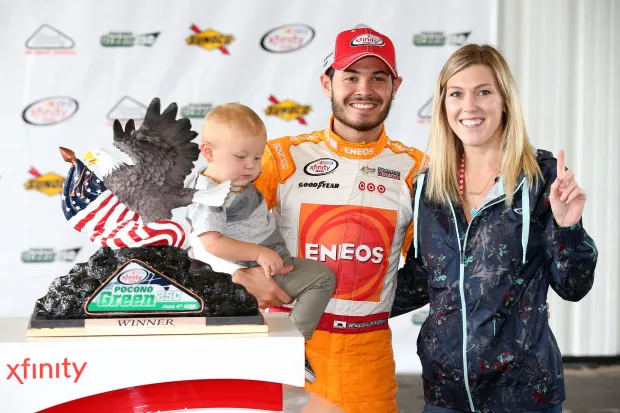 Kyle Larson, driver of the #42 Cessna/NTT Data Group Chevrolet, poses with Katelyn Sweet and son Owen (Image via Getty)