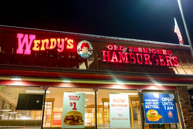 Night view of Wendy's fast food restaurant chain location in Dublin, California, with sign advertising late night hours, March 5, 2018. (Photo by Smith Collection/Gado/Getty Images)