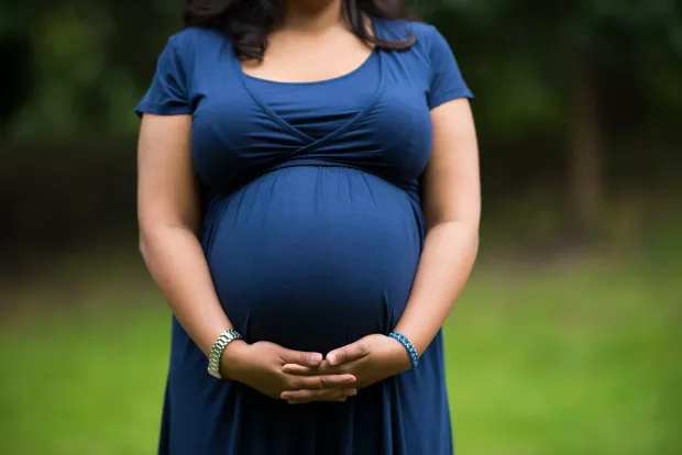 CARDIFF, UNITED KINGDOM - SEPTEMBER 27: A pregnant woman holds her belly on September 27, 2016 in Cardiff, United Kingdom. (Photo by Matthew Horwood/Getty Images)
