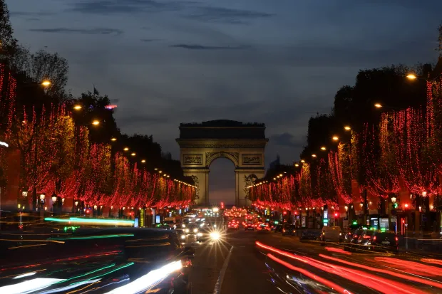 PARIS, FRANCE - NOVEMBER 24: Red lights decorate the trees to illuminate the Champs-Elysees avenue with the Arc de Triomphe in the background for Christmas and New Year celebrations on November 24, 2020 in Paris, France. (Photo by Pascal Le Segretain/Getty Images)