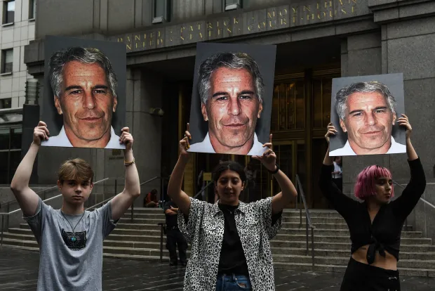 NEW YORK, NY - JULY 08: A protest group called "Hot Mess" hold up signs of Jeffrey Epstein in front of the Federal courthouse on July 8, 2019 in New York City. According to reports, Epstein will be charged with one count of sex trafficking of minors and one count of conspiracy to engage in sex trafficking of minors. (Photo by Stephanie Keith/Getty Images)