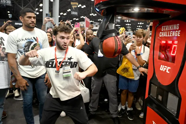 NEW YORK, NEW YORK - AUGUST 16: (L-R) Alex Pereira and Adin Ross attend the Fanatics Fest NYC 2024 at Jacob Javits Center on August 16, 2024 in New York City.  (Photo by Dave Kotinsky/Getty Images for Fanatics)